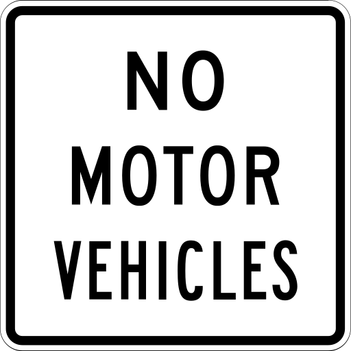 A white square sign with a black border and the black words NO MOTOR VEHICLES on three lines.