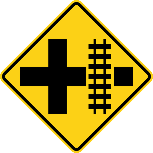 A yellow diamond sign with a black border, a black cross, and a black railroad track symbol across the right arm of the cross.